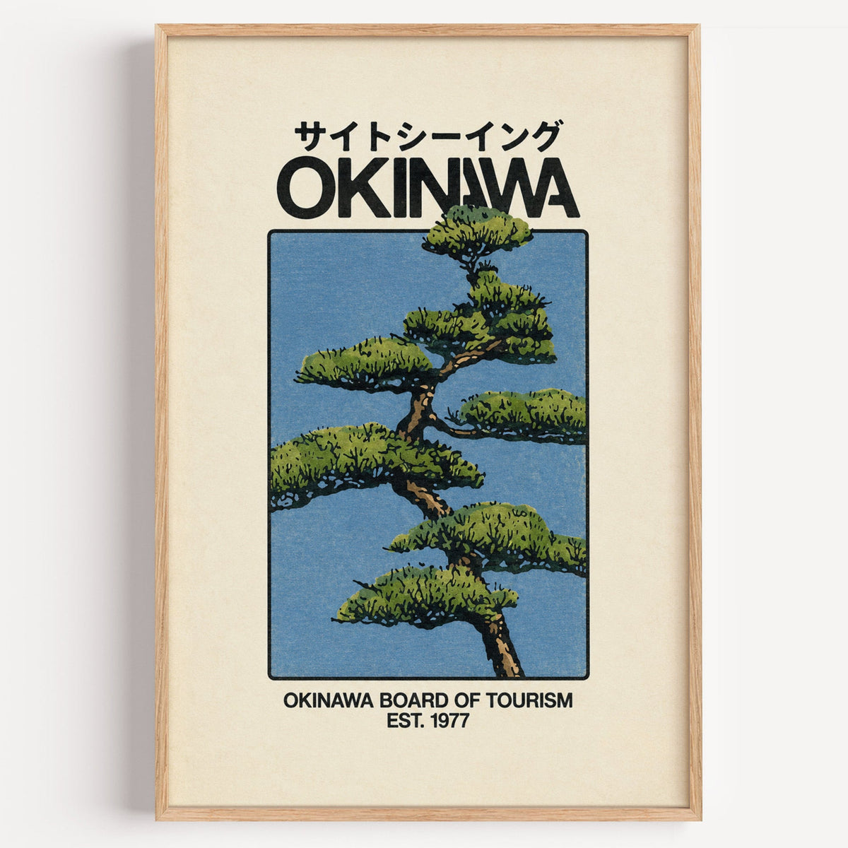 Okinawa pine tree travel poster print in a light oak frame on a plain white wall