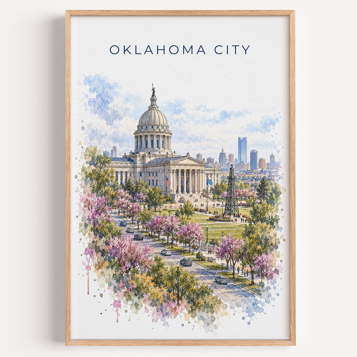 Oklahoma City watercolor print in a light oak frame on a plain white wall