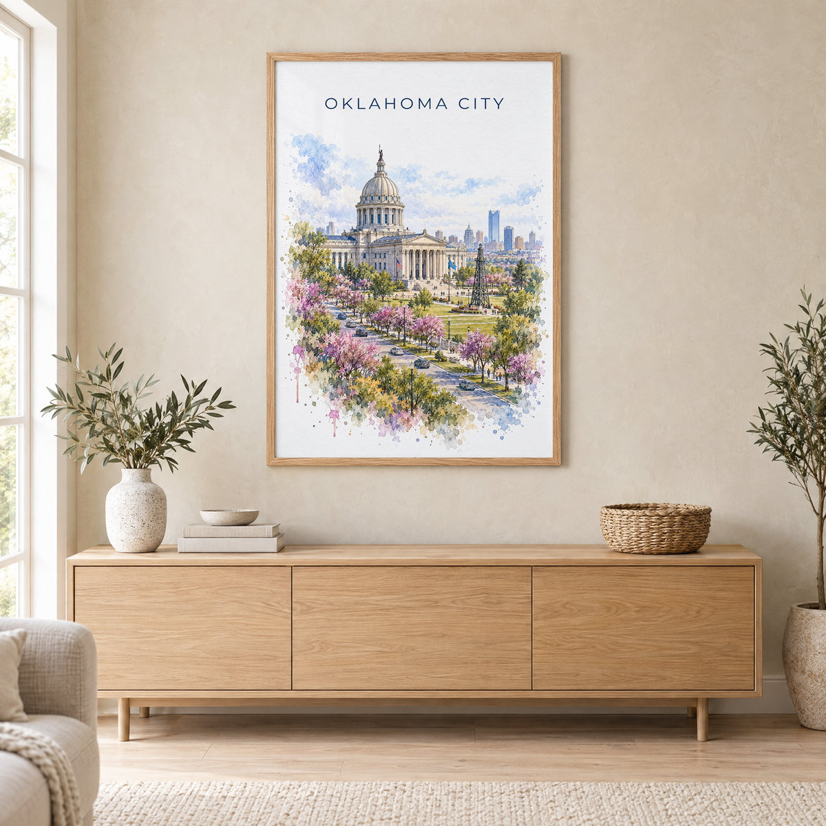 Oklahoma City watercolor print in an oak frame above a light wood sideboard in a Scandinavian living room