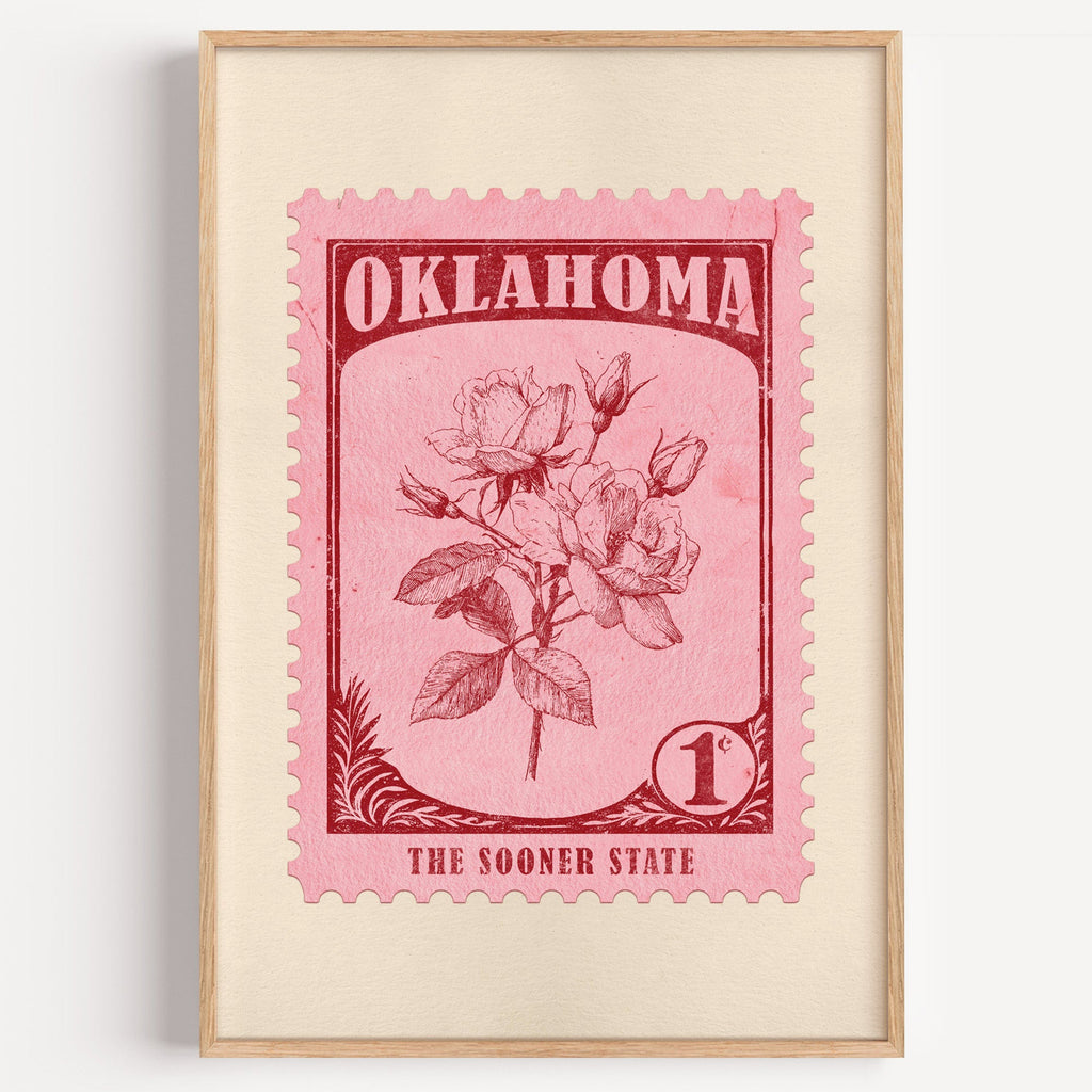 Oklahoma state flower stamp print in rose red on pink, light oak frame on a plain white wall