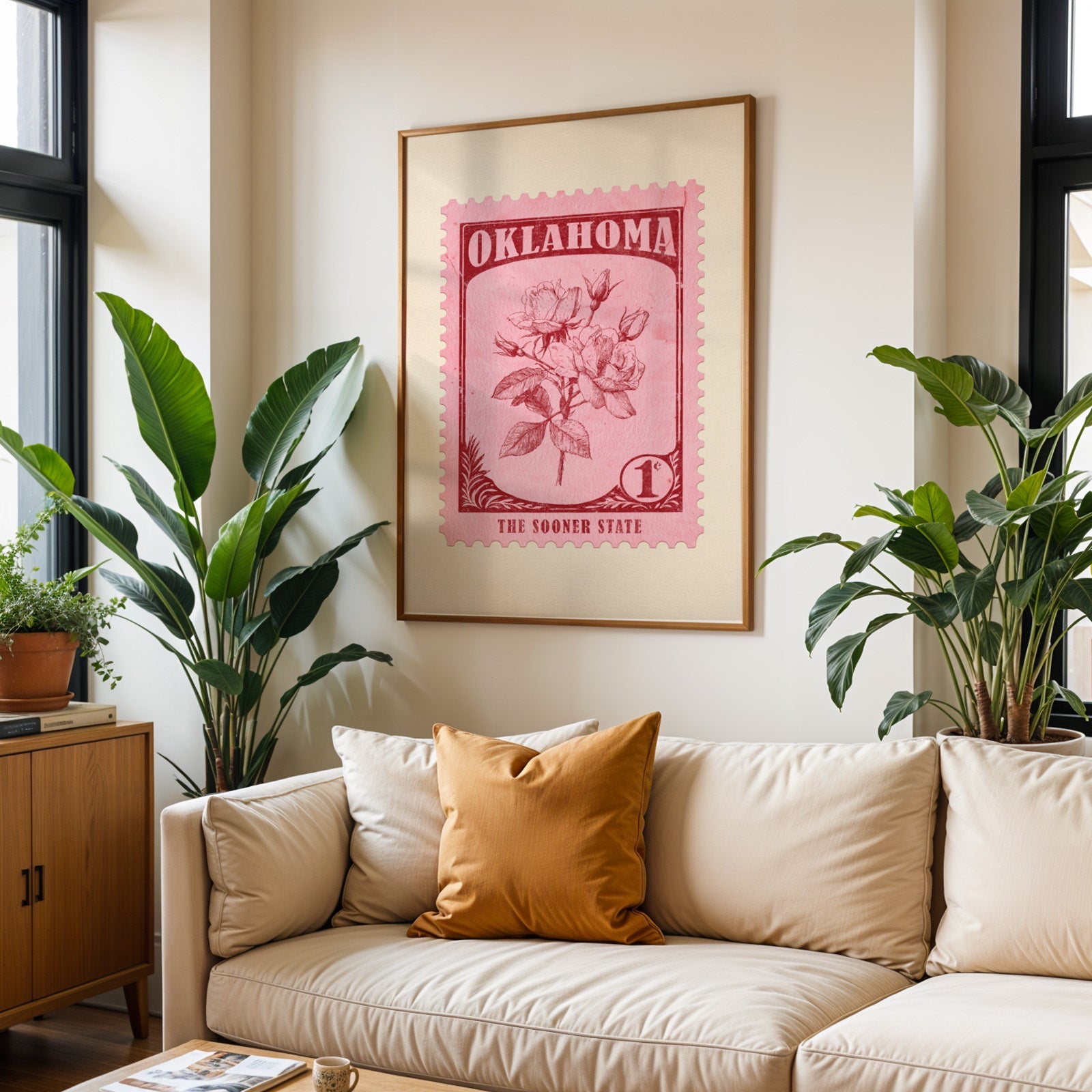Oklahoma state flower print framed above a cream sofa with an ochre cushion and large plants either side