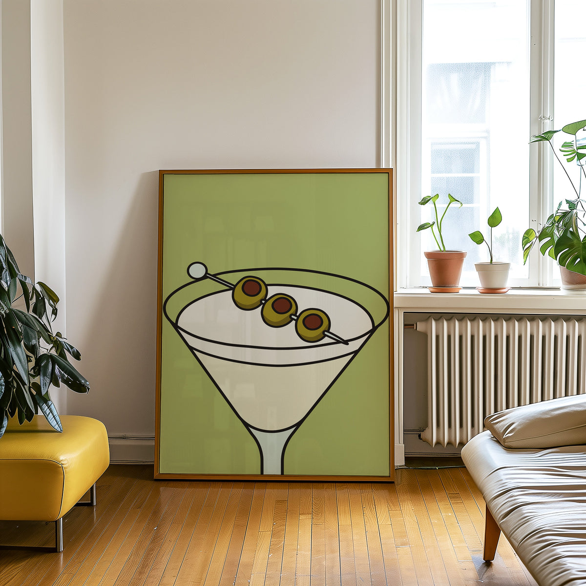 Olive martini green block print in an oak frame leaning on a wooden floor beside a yellow leather bench