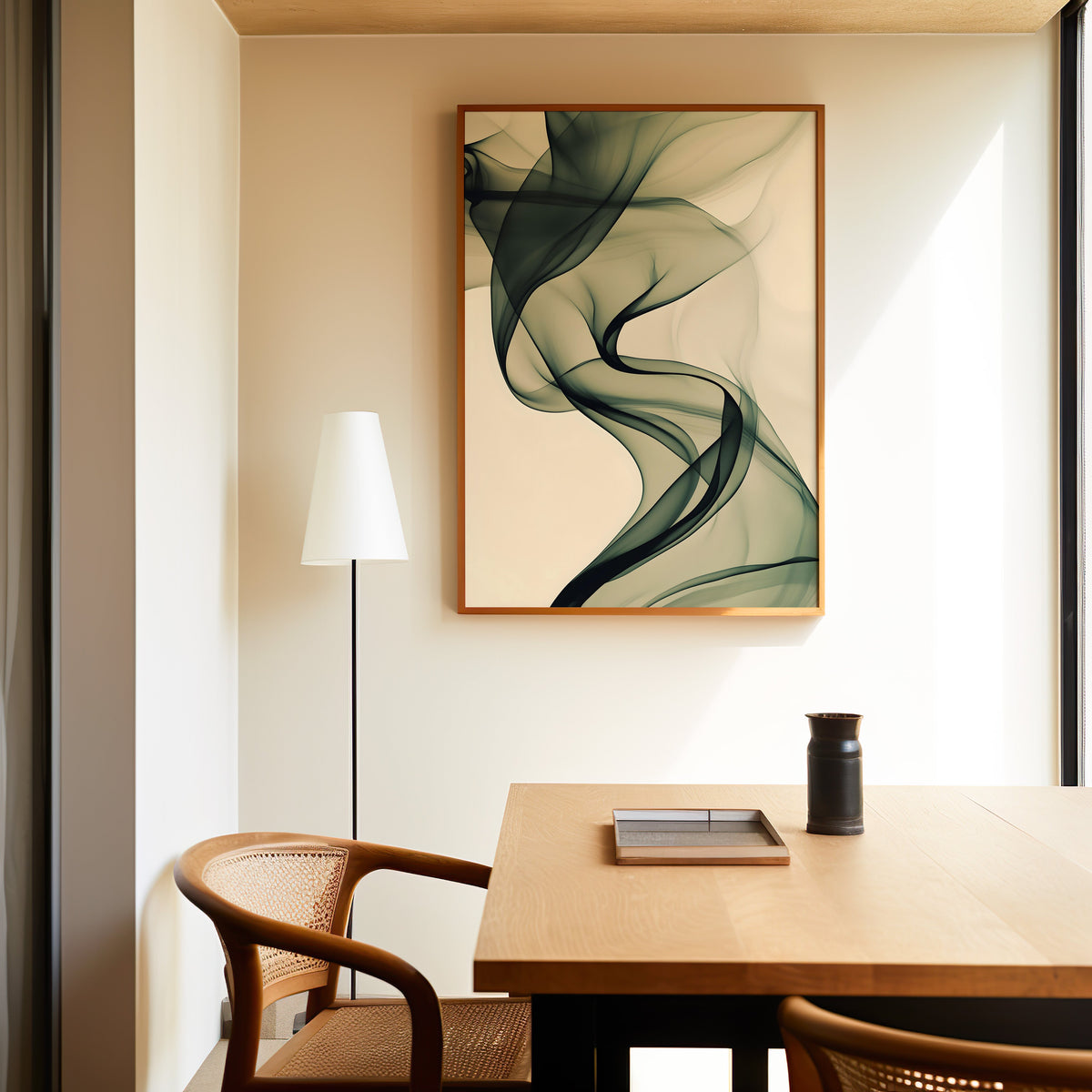 Olive smoke on cream fluid abstract print in a slim oak frame above a dining table with a cane-back chair