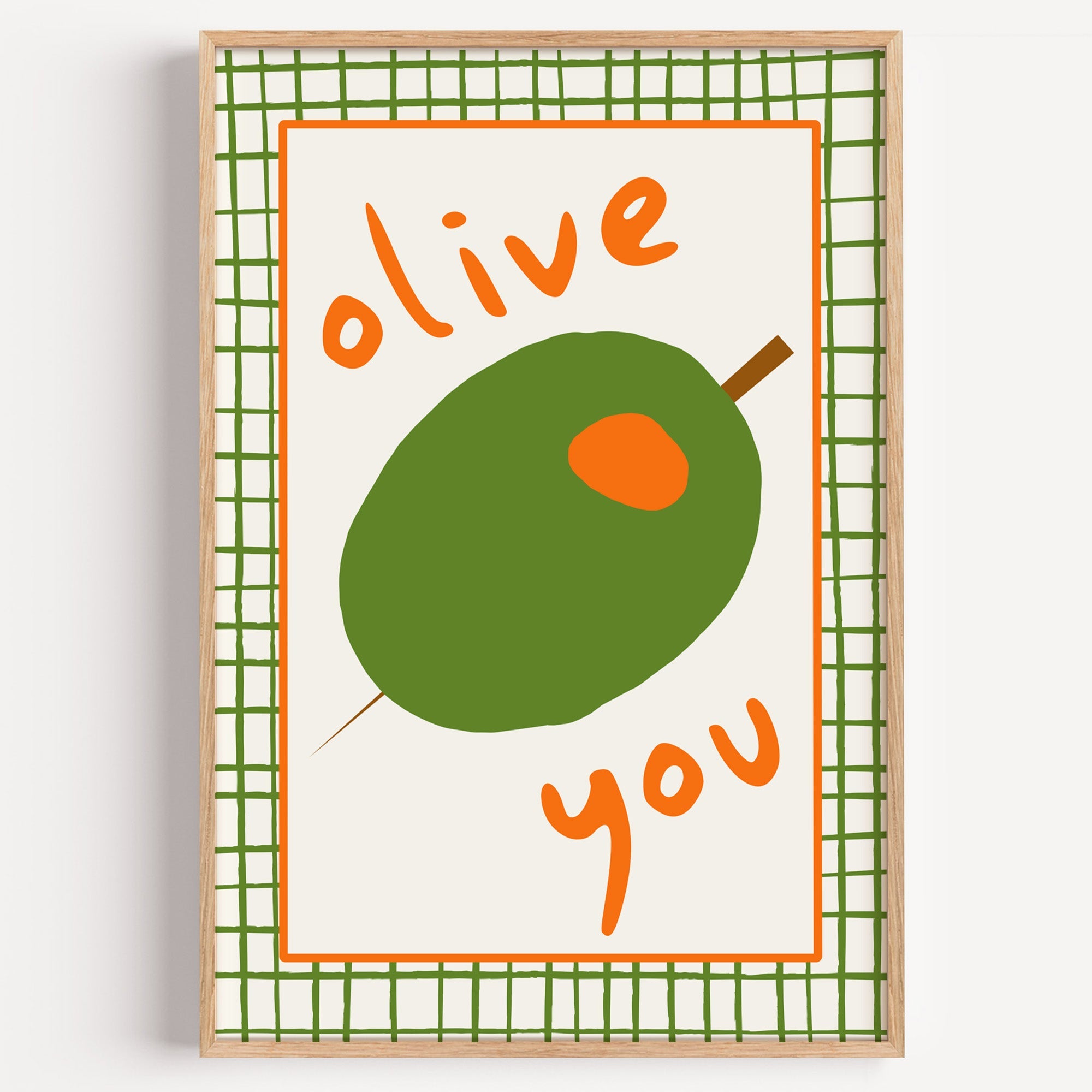 Olive you green olive print in a light oak frame on a plain white wall