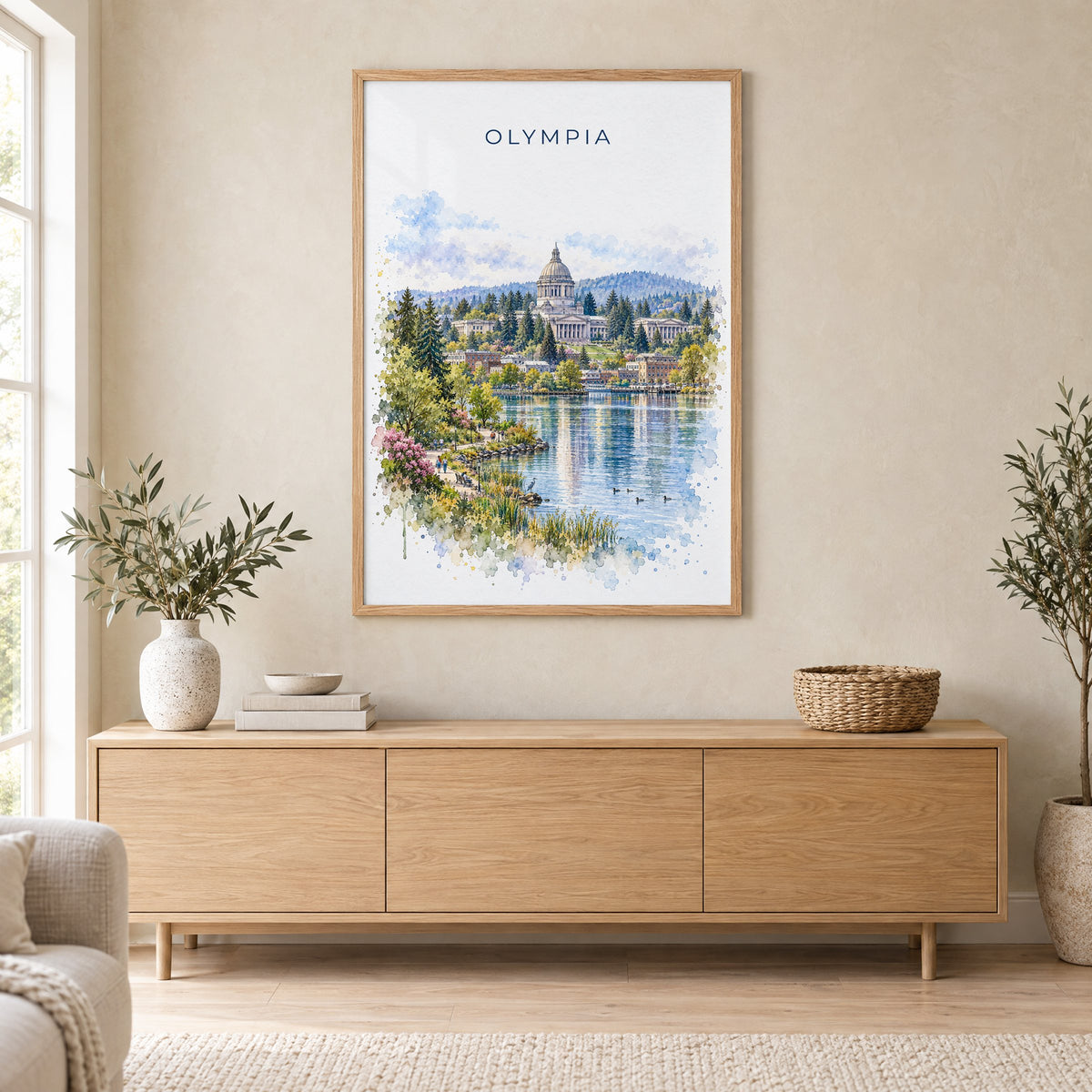 Olympia, Washington watercolor print in an oak frame above a light wood sideboard in a Scandinavian living room