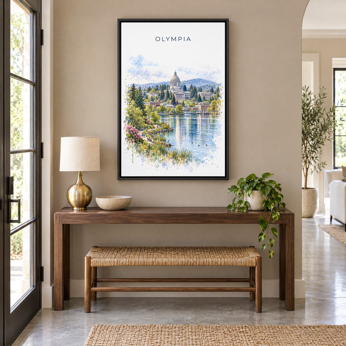Olympia, Washington watercolor print as a black floater canvas above a walnut console and woven bench in an entryway