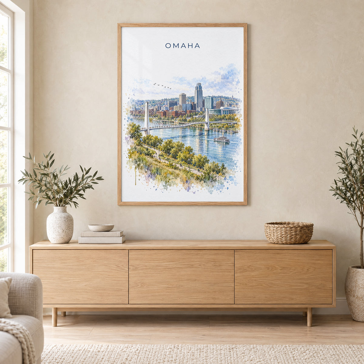 Omaha watercolor print in an oak frame above a light wood sideboard in a Scandinavian living room