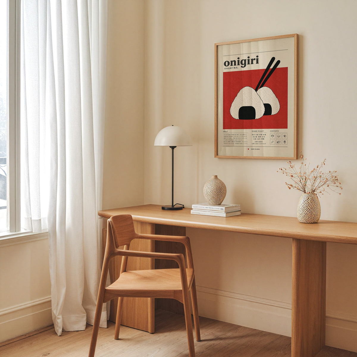 onigiri rice balls on red print in an oak frame above a long oak desk with a white dome lamp and woven vases