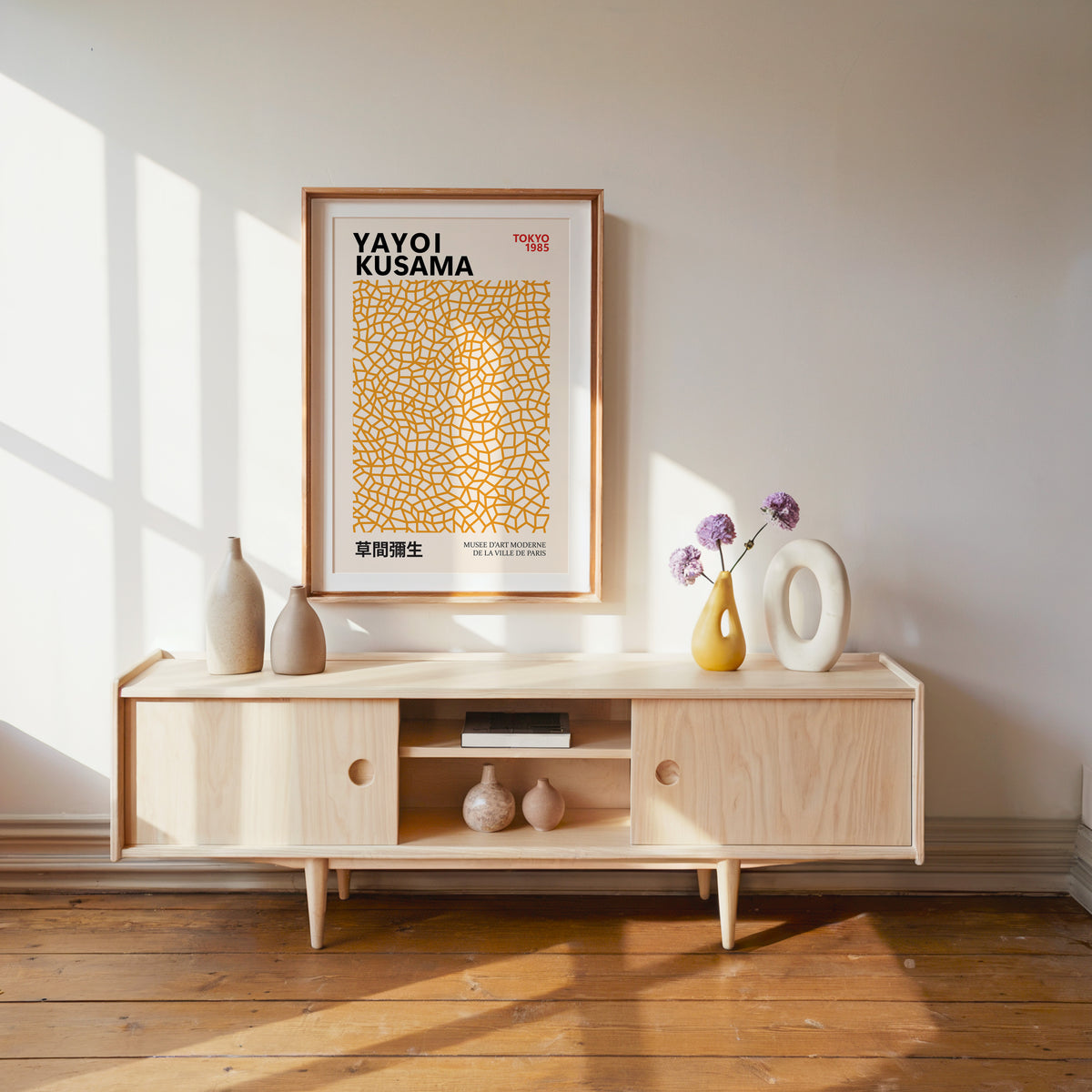 Yayoi Kusama inspired orange net pattern print above a pale wood console