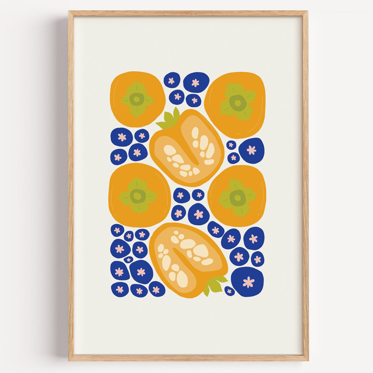 orange persimmons cobalt blueberries pattern print in a light oak frame on a plain white wall