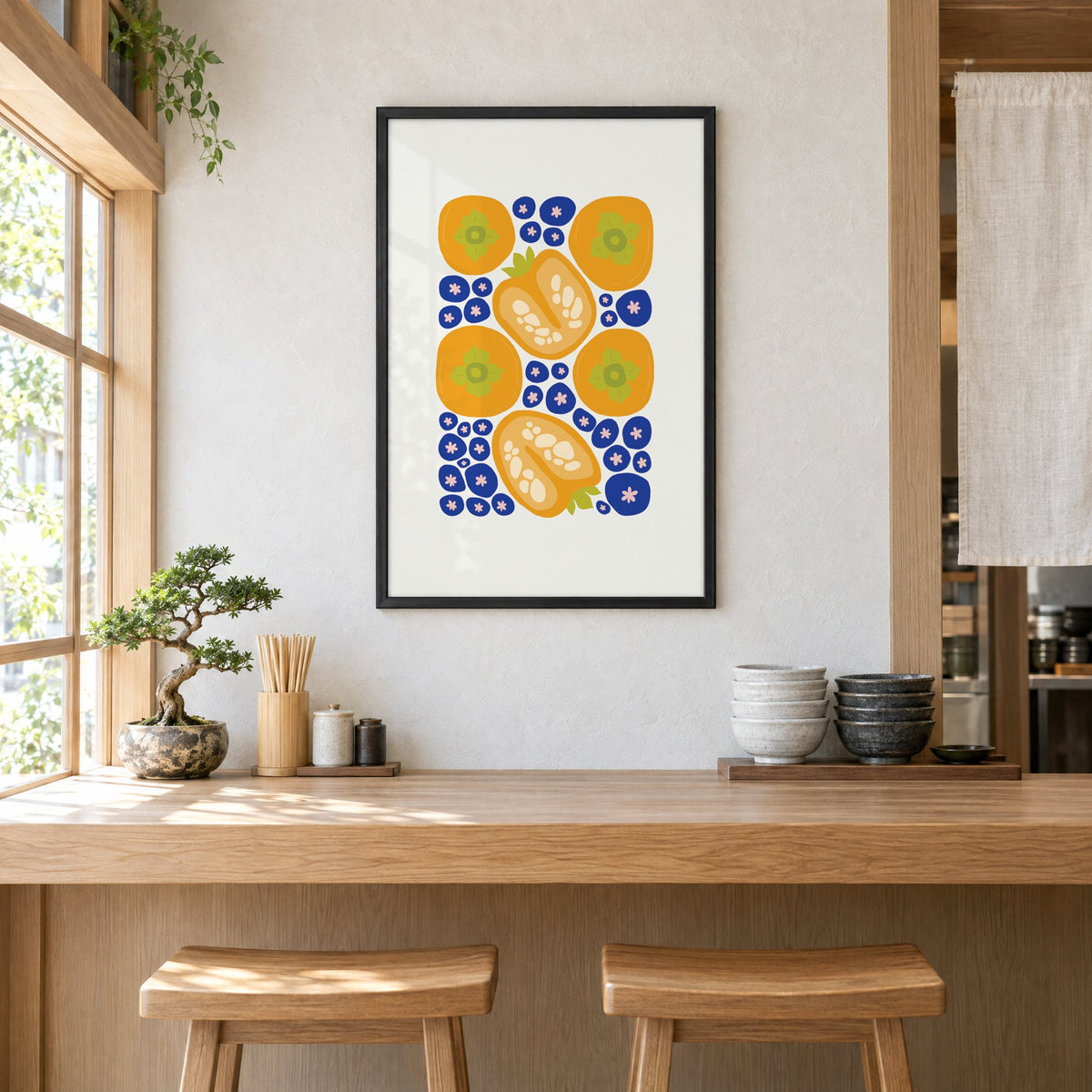 orange persimmons cobalt blueberries pattern print in a black frame above a light wood ramen counter with stools and stacked bowls