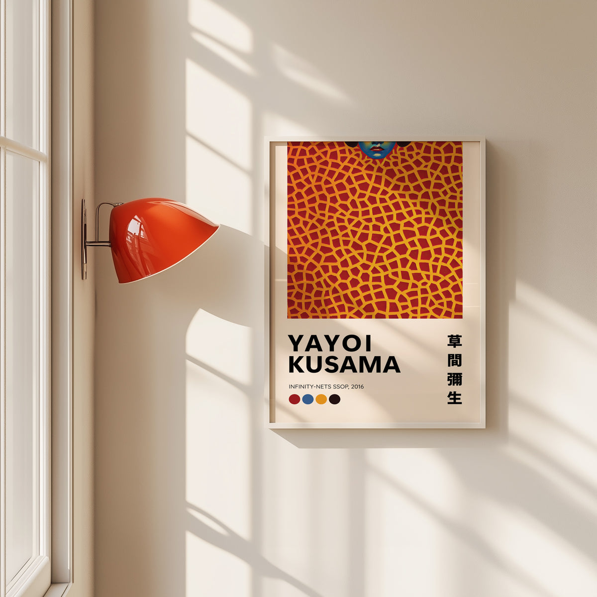 Yayoi Kusama inspired orange net and lips print in a white frame by a red wall lamp