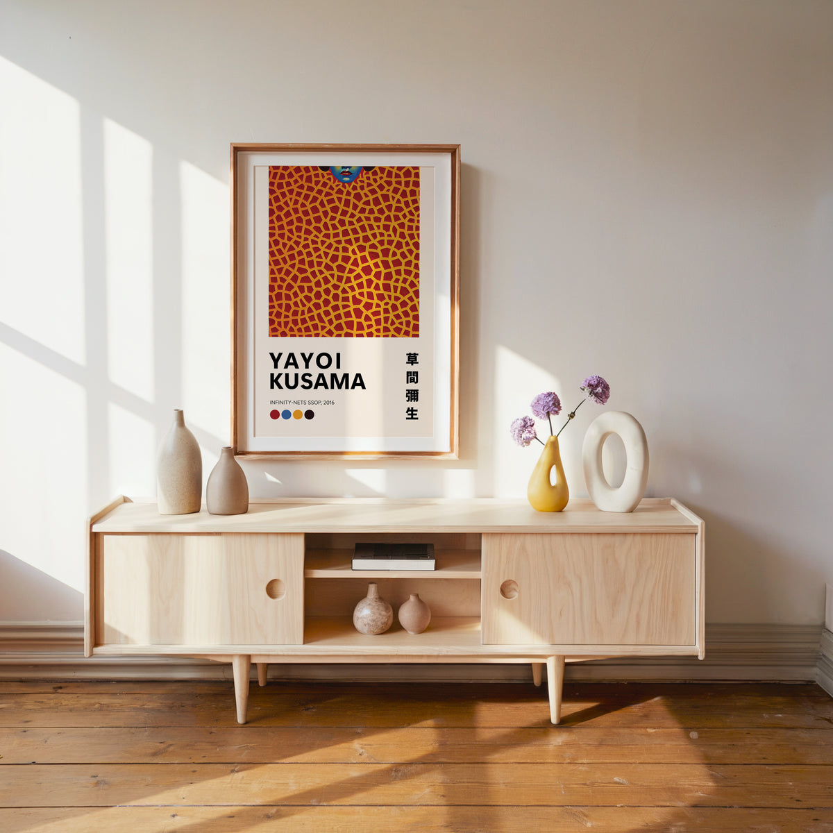 Yayoi Kusama inspired orange net and lips print above a pale wood console