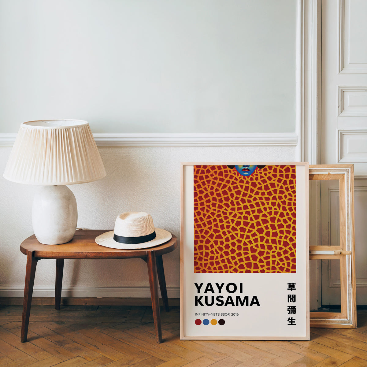 Yayoi Kusama inspired orange net and lips print beside a bench and straw hat