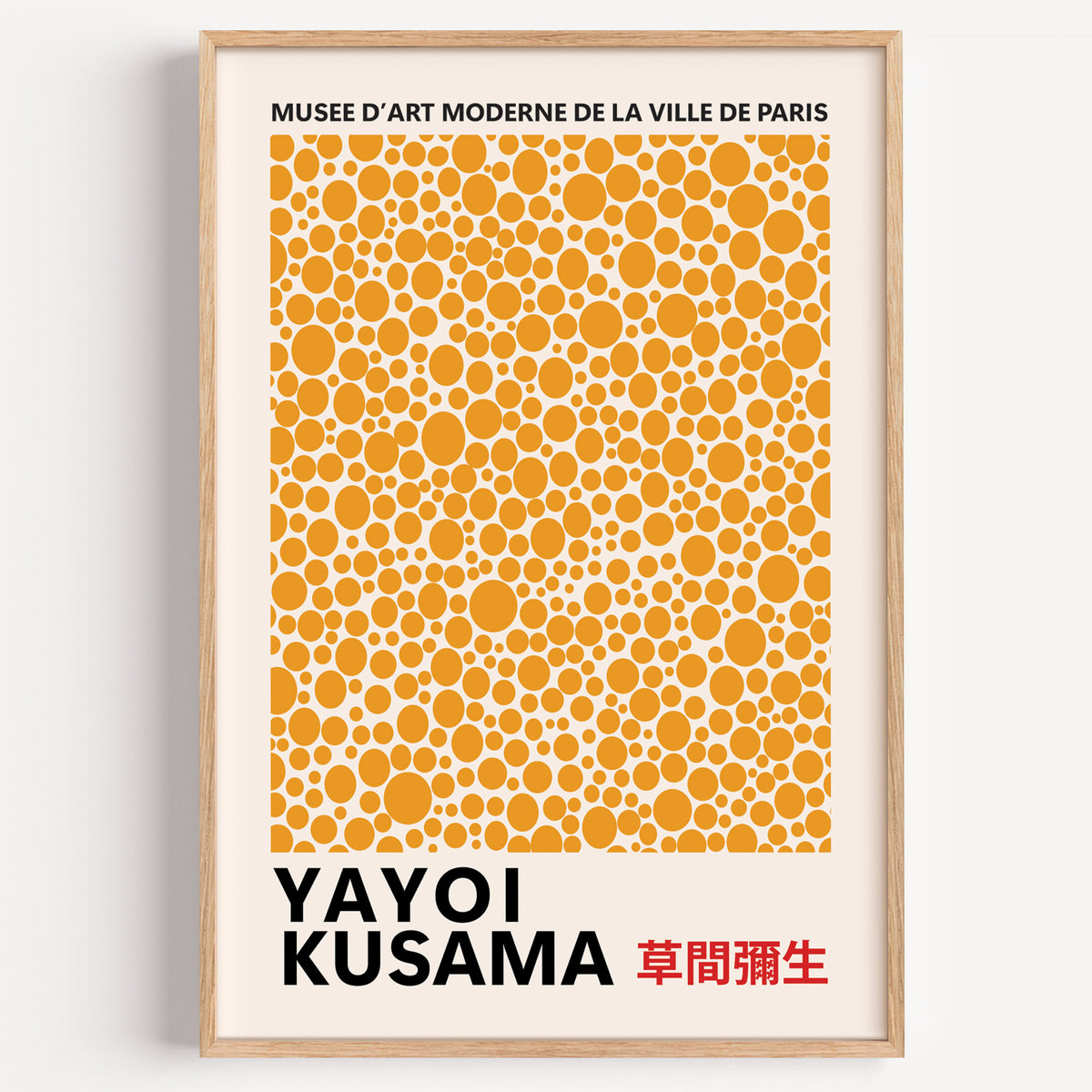 Yayoi Kusama inspired orange polka dot pattern print in a wood frame on a plain wall