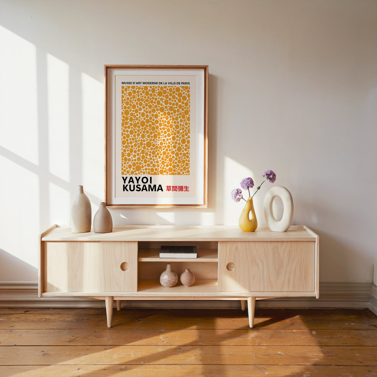 Yayoi Kusama inspired orange polka dot pattern print above a pale wood console