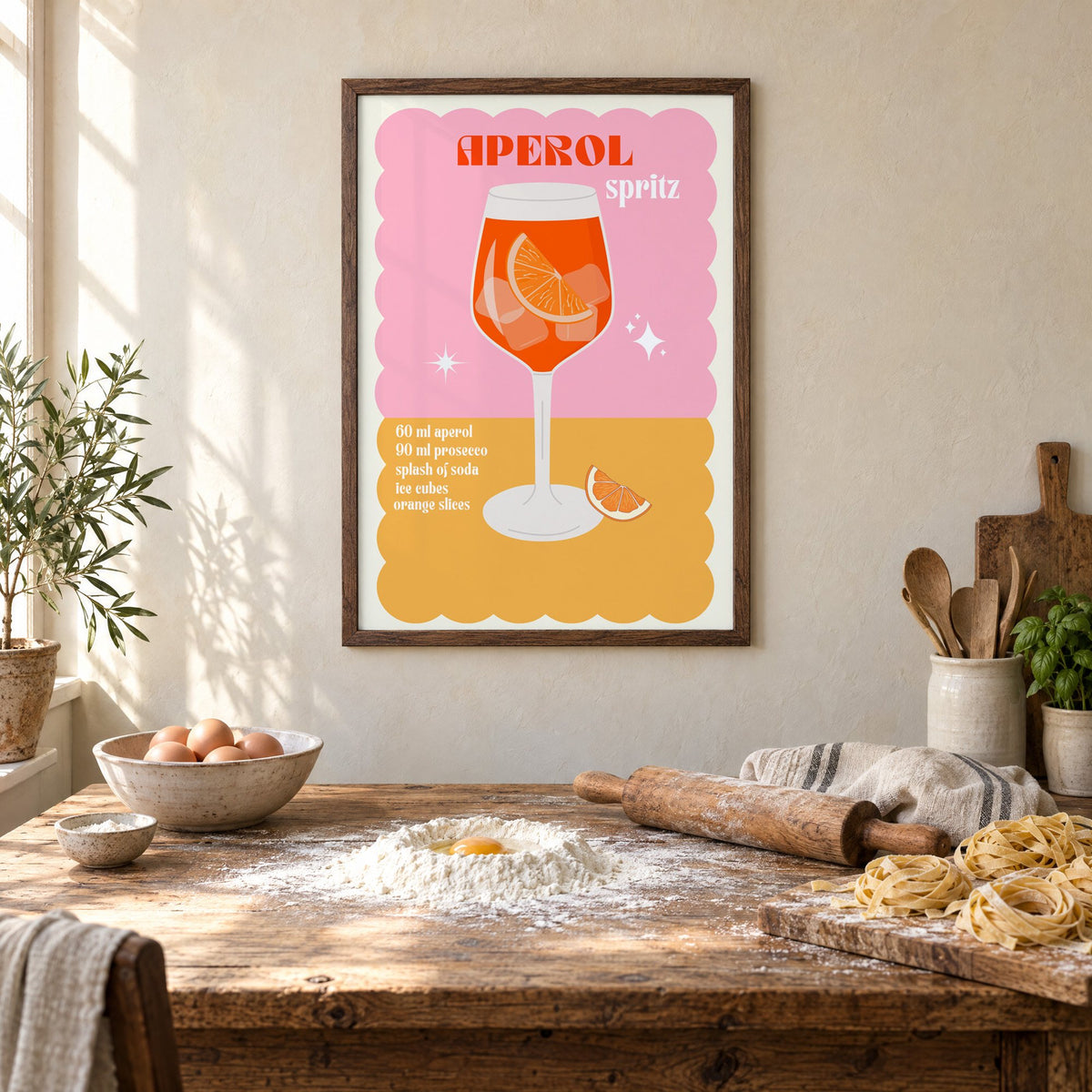 Orange spritz scalloped pink print in a walnut frame above a rustic table set for making fresh pasta