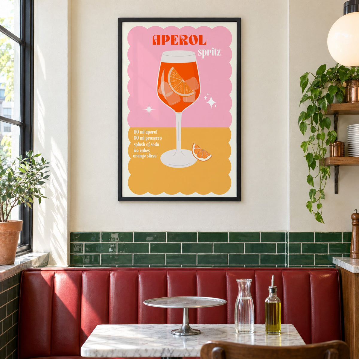 Orange spritz scalloped pink print in a black frame above a red leather booth in a sunny pizzeria