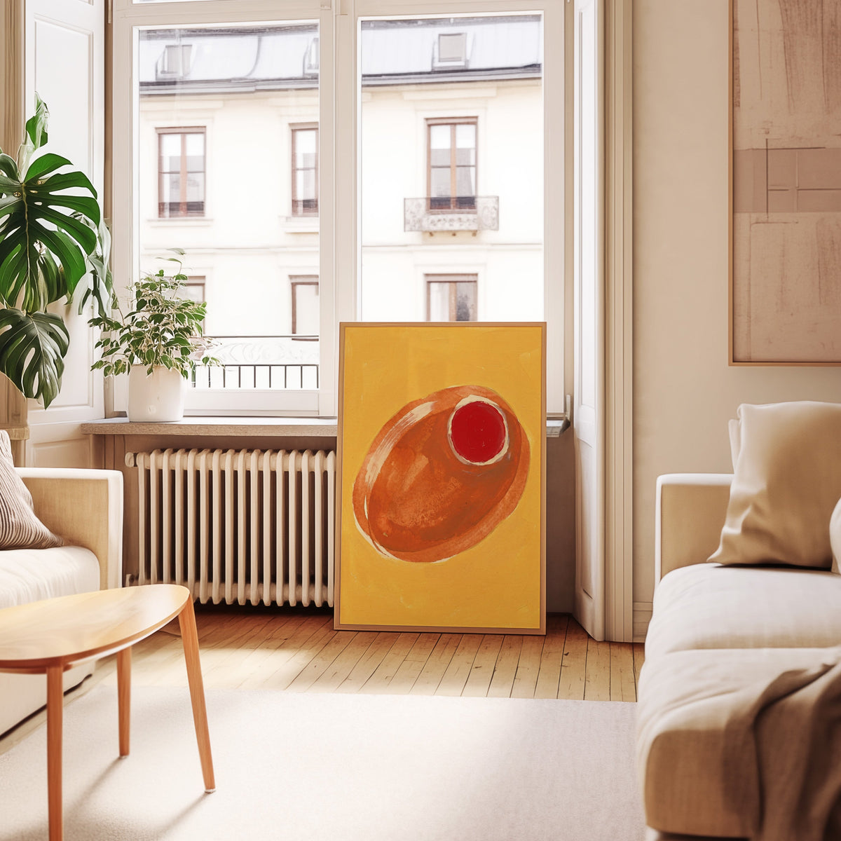 Warm orange olive print in an oak frame leaning below tall French windows