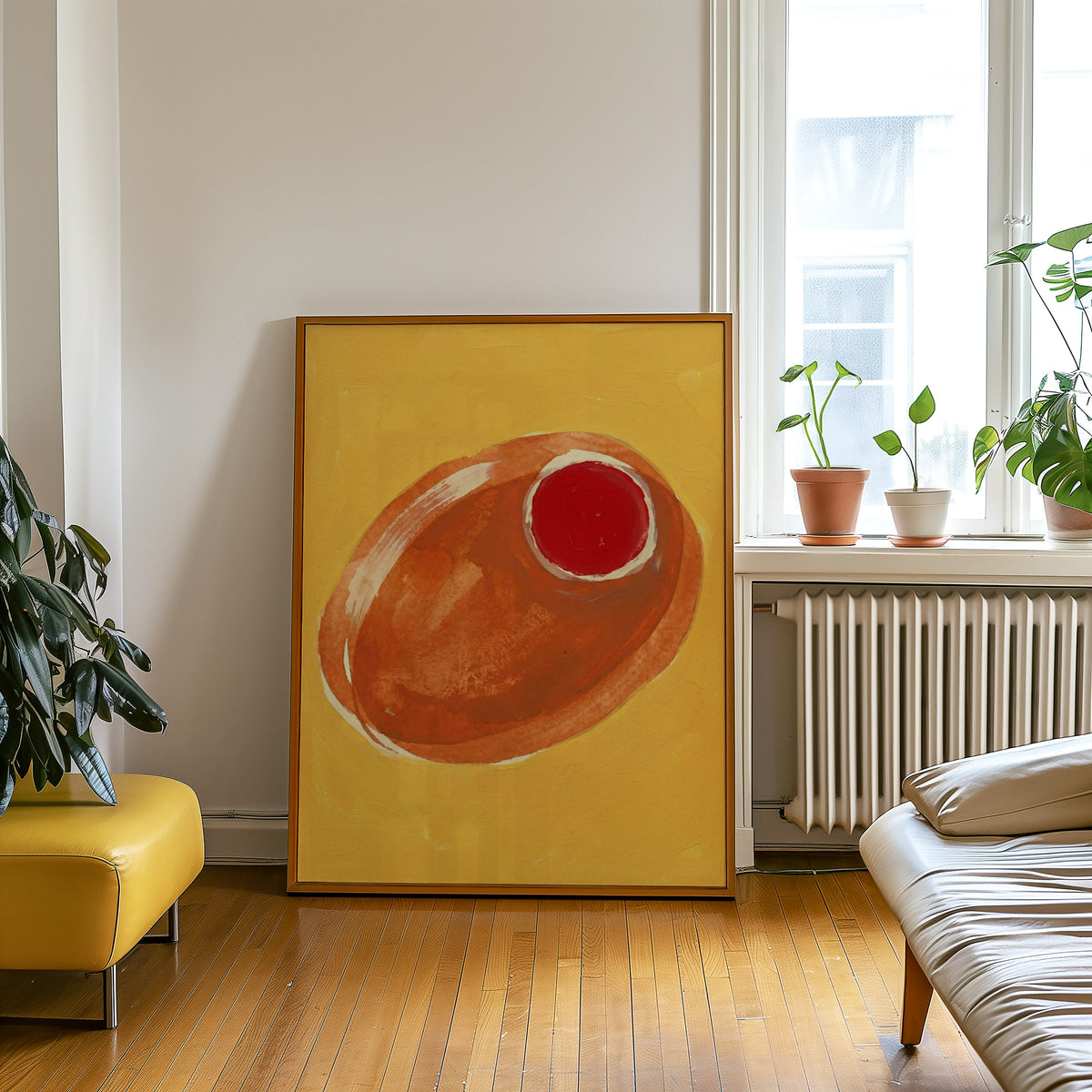 Mustard and orange olive print in an oak frame leaning beside a yellow leather bench