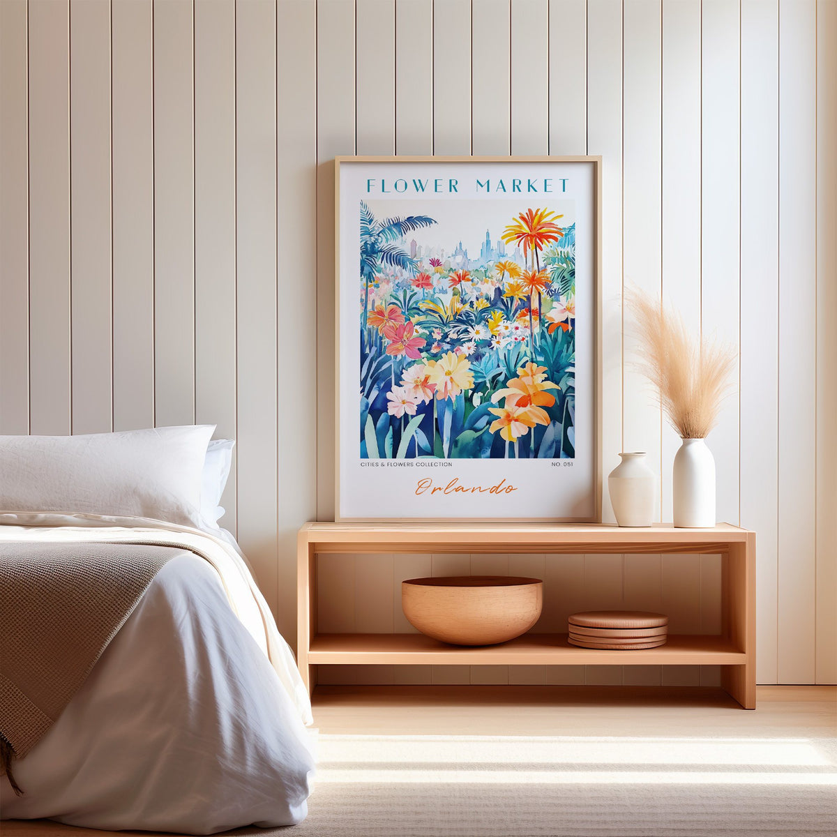 Orlando flower market print in an oak frame on a wood bench against a white shiplap bedroom wall with pampas grass