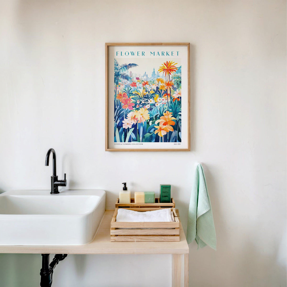 Orlando flower market print in an oak frame above a white bathroom sink with folded towels