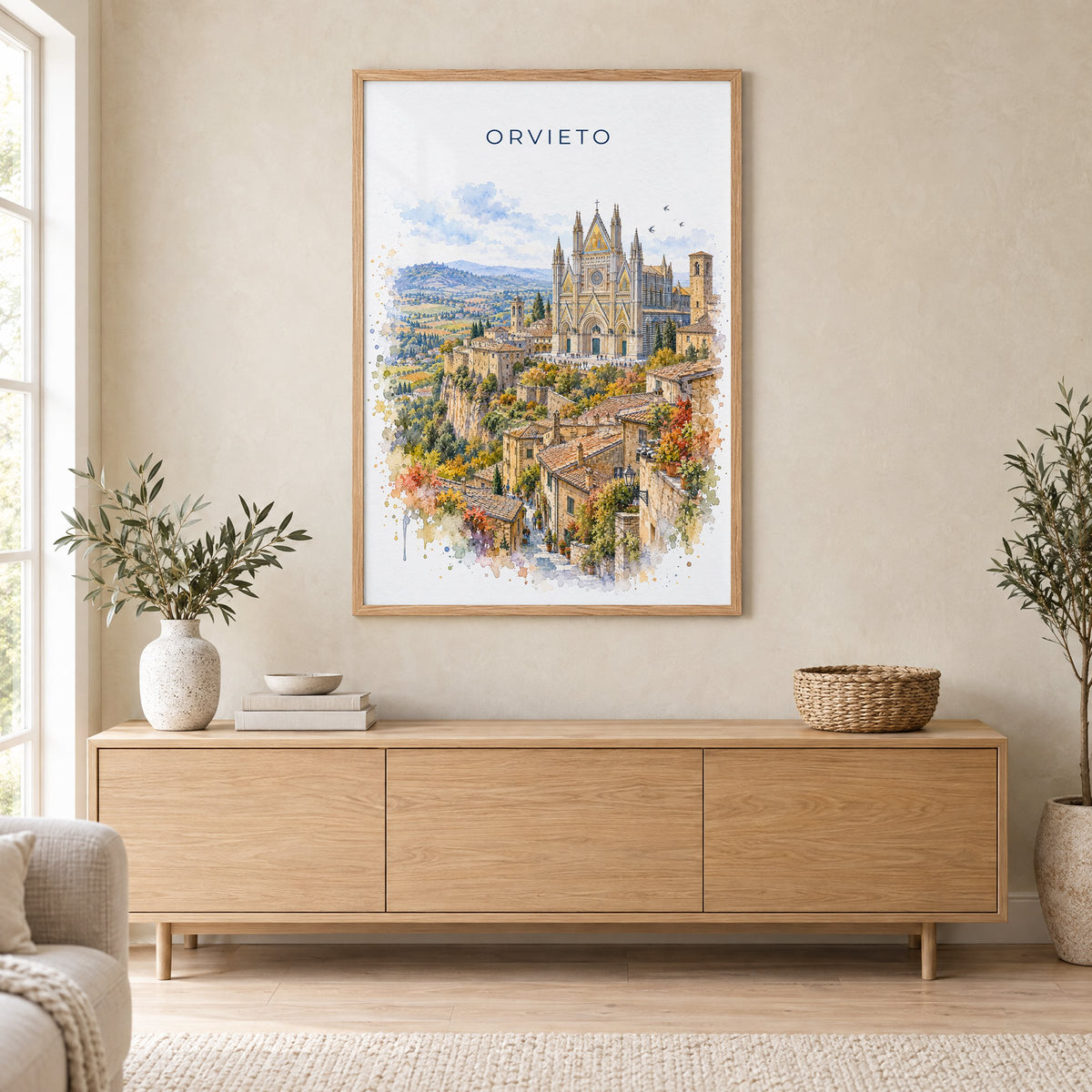 Orvieto watercolor print in an oak frame above a light wood sideboard in a Scandinavian living room