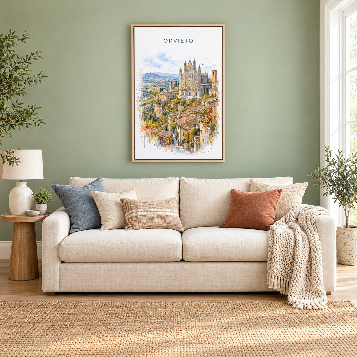 Orvieto watercolor print as a natural floater canvas above a cream linen sofa on a sage green wall