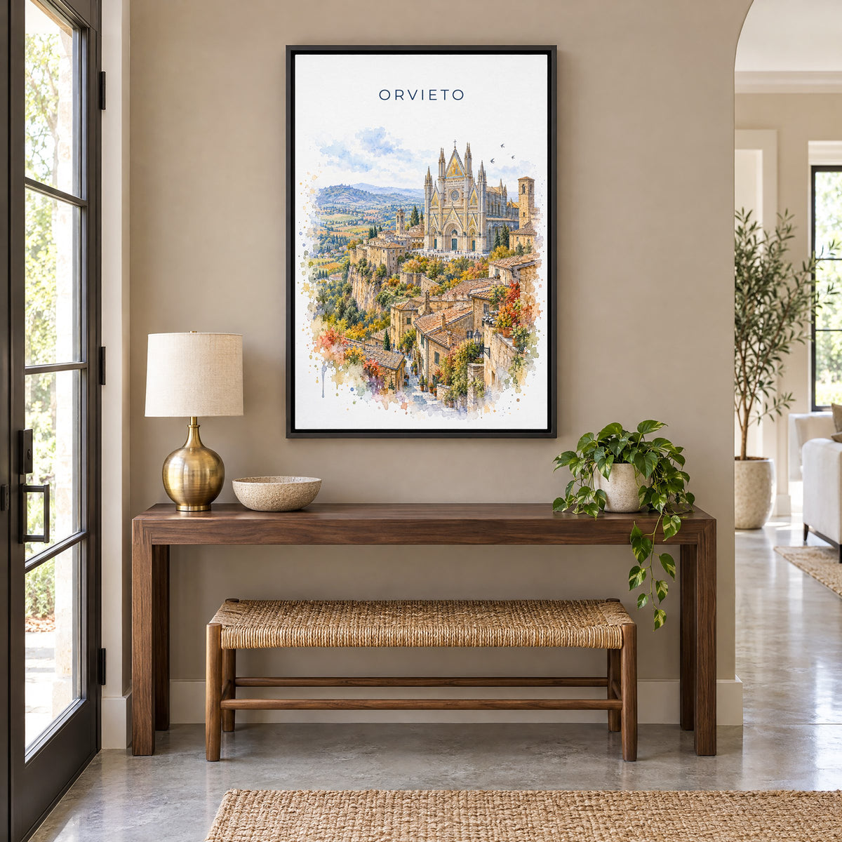 Orvieto watercolor print as a black floater canvas above a walnut console and woven bench in an entryway