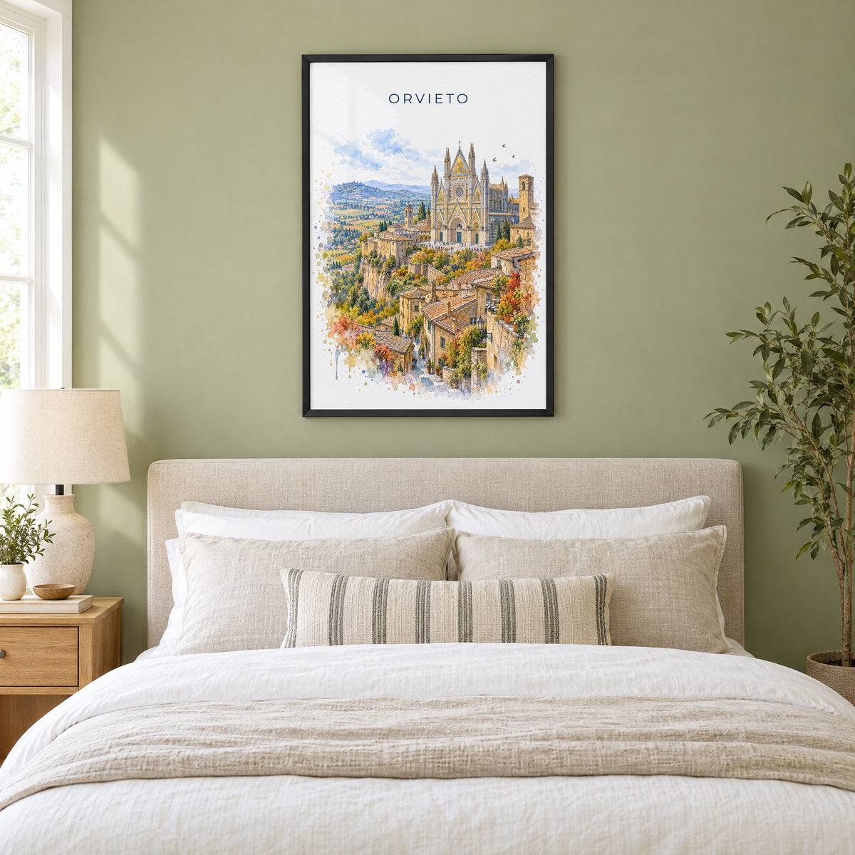 Orvieto watercolor print in a black frame above an upholstered headboard in a sage green bedroom