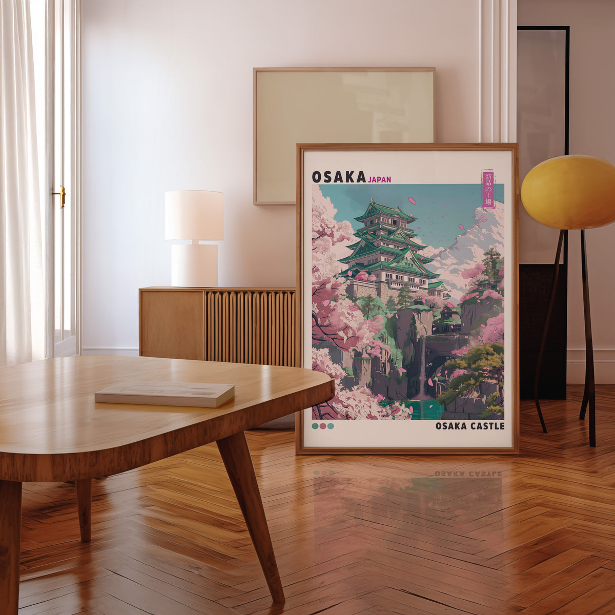 Osaka Castle with cherry blossoms print in a walnut frame leaning in a mid-century living room