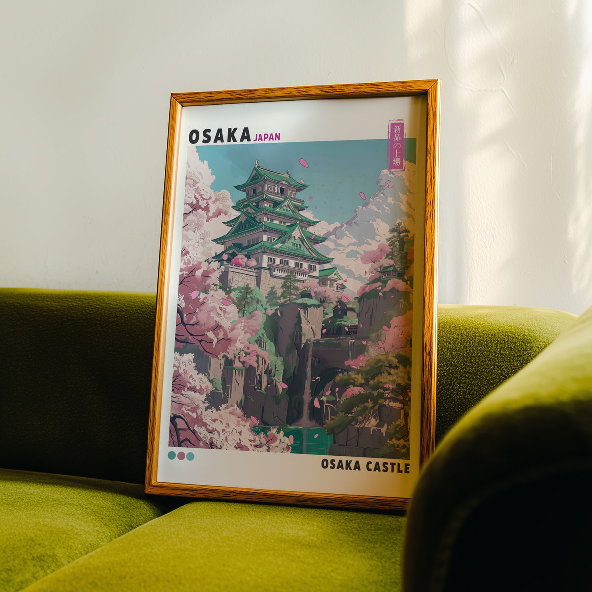 Osaka Castle with cherry blossoms print in an oak frame propped on a green velvet sofa