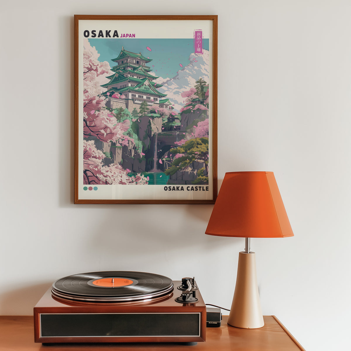 Osaka Castle with cherry blossoms print in a walnut frame above a sideboard with a record player