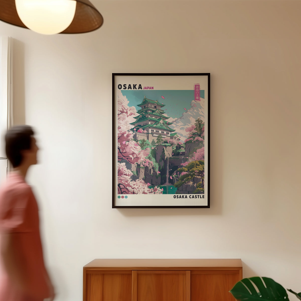 Osaka Castle with cherry blossoms print in a black frame in a hallway under a rattan pendant