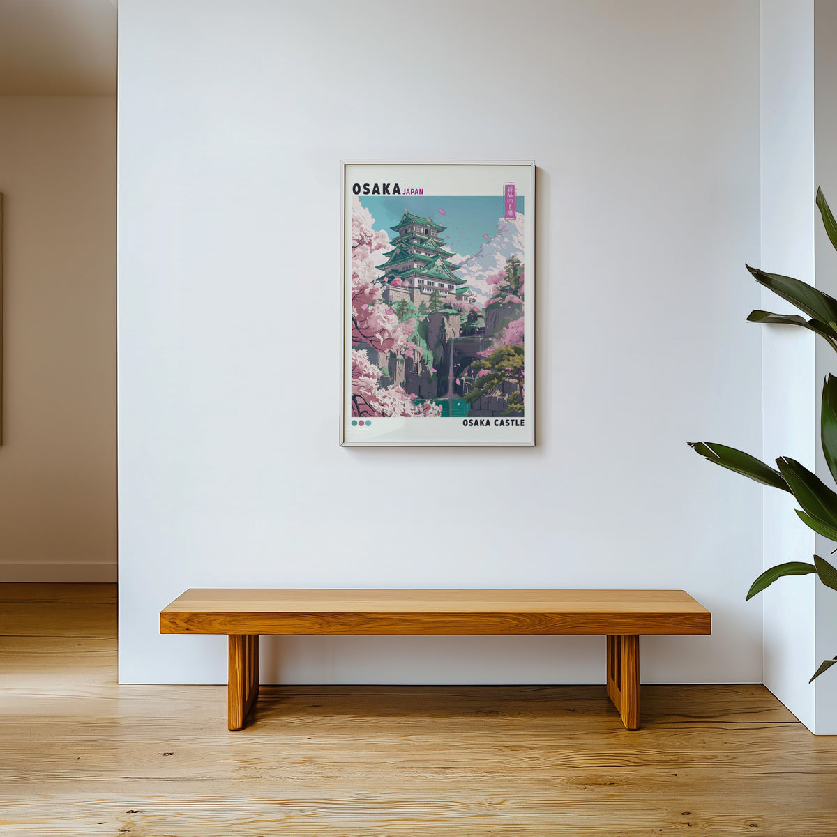 Osaka Castle with cherry blossoms print shown in a white frame above a wooden entryway bench