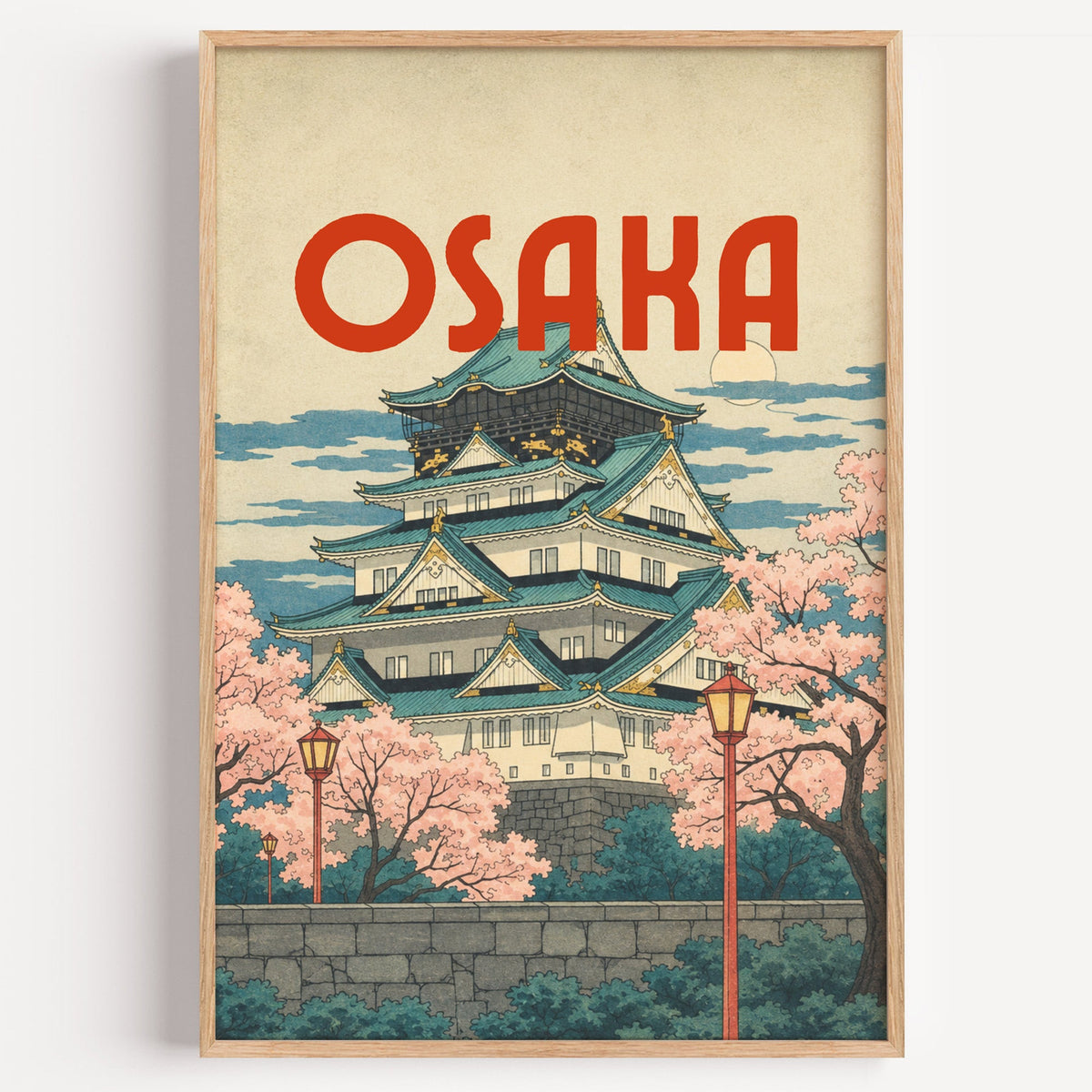 Osaka Castle with teal roofs print in a light oak frame on a plain white wall