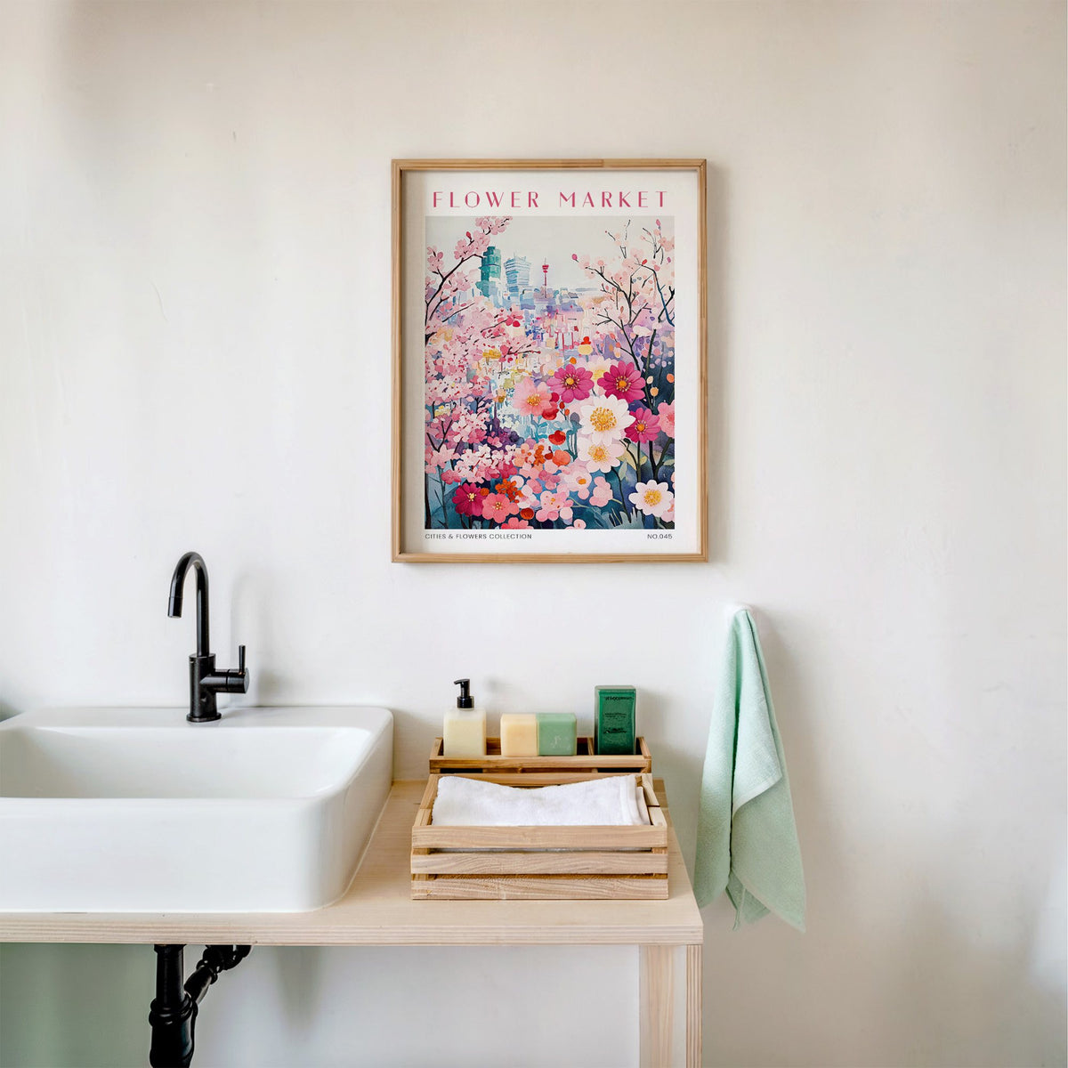 Osaka flower market print in an oak frame above a white bathroom sink with folded towels