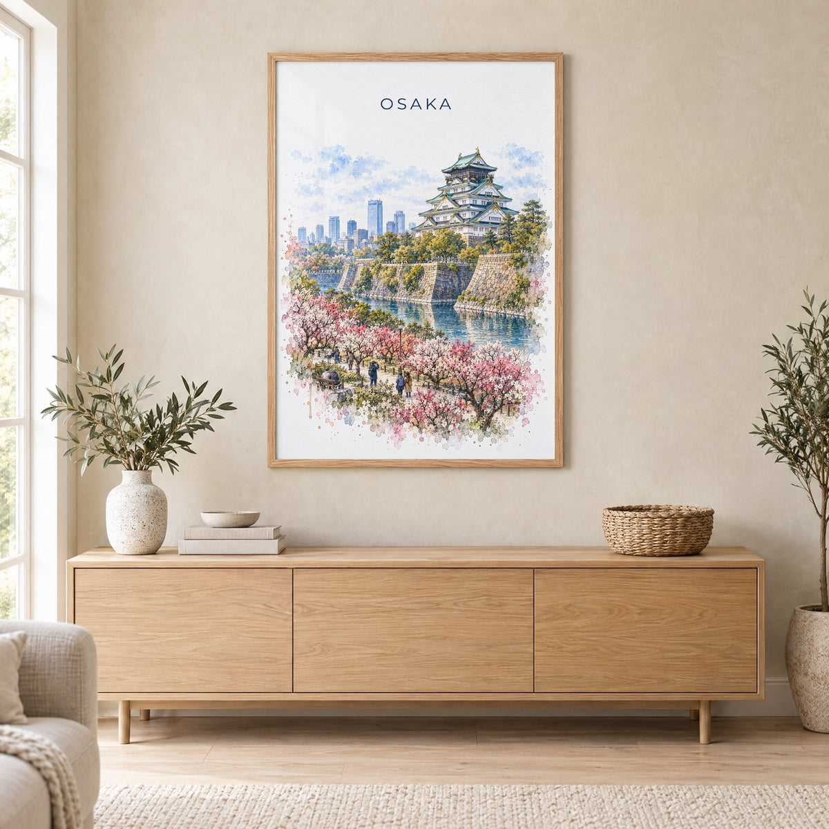 Osaka watercolor print in an oak frame above a light wood sideboard in a Scandinavian living room