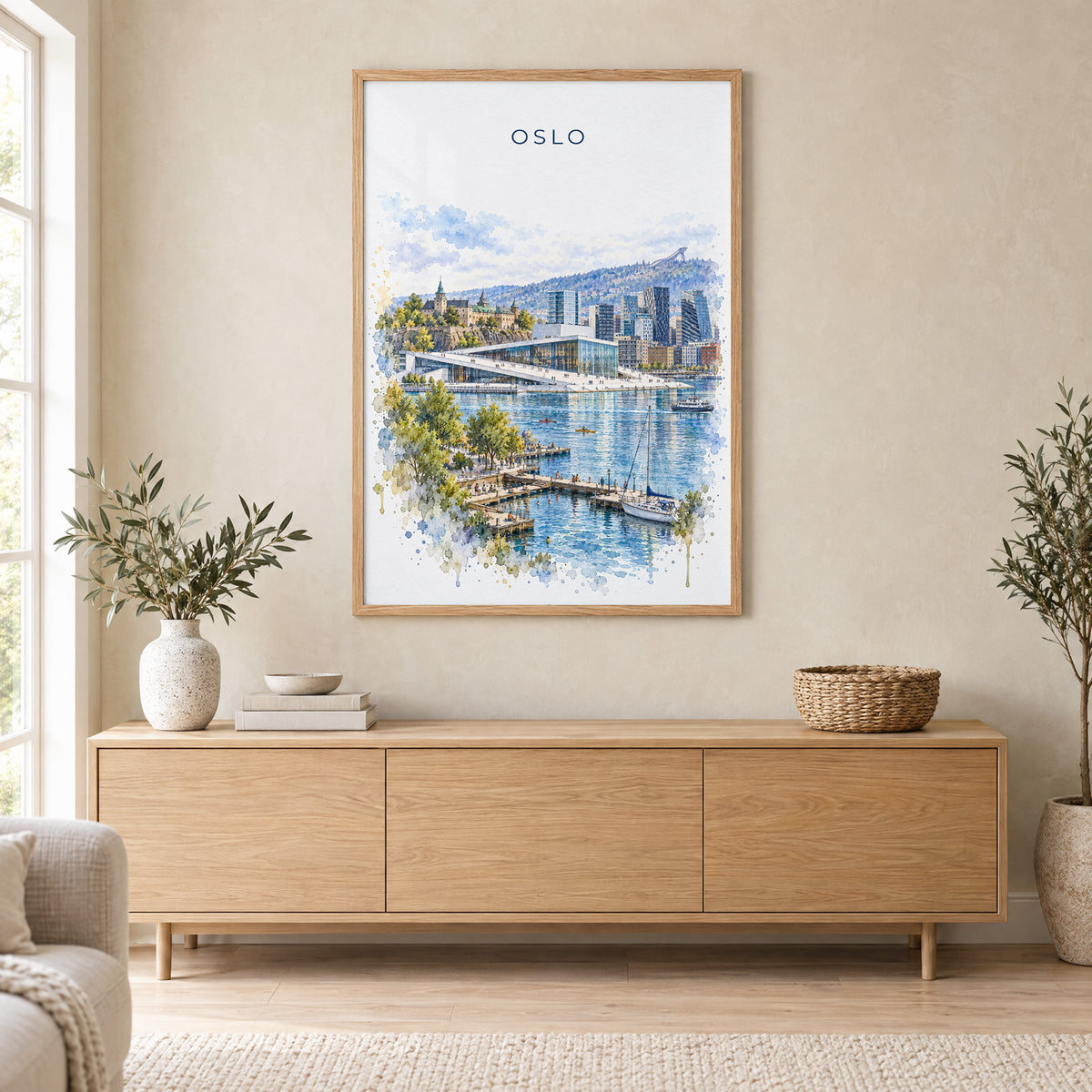 Oslo watercolor print in an oak frame above a light wood sideboard in a Scandinavian living room