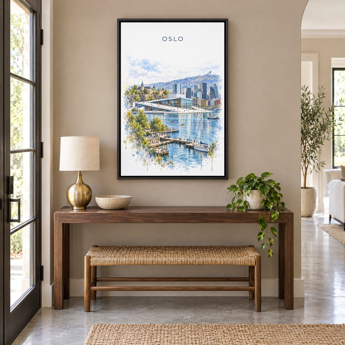 Oslo watercolor print as a black floater canvas above a walnut console and woven bench in an entryway