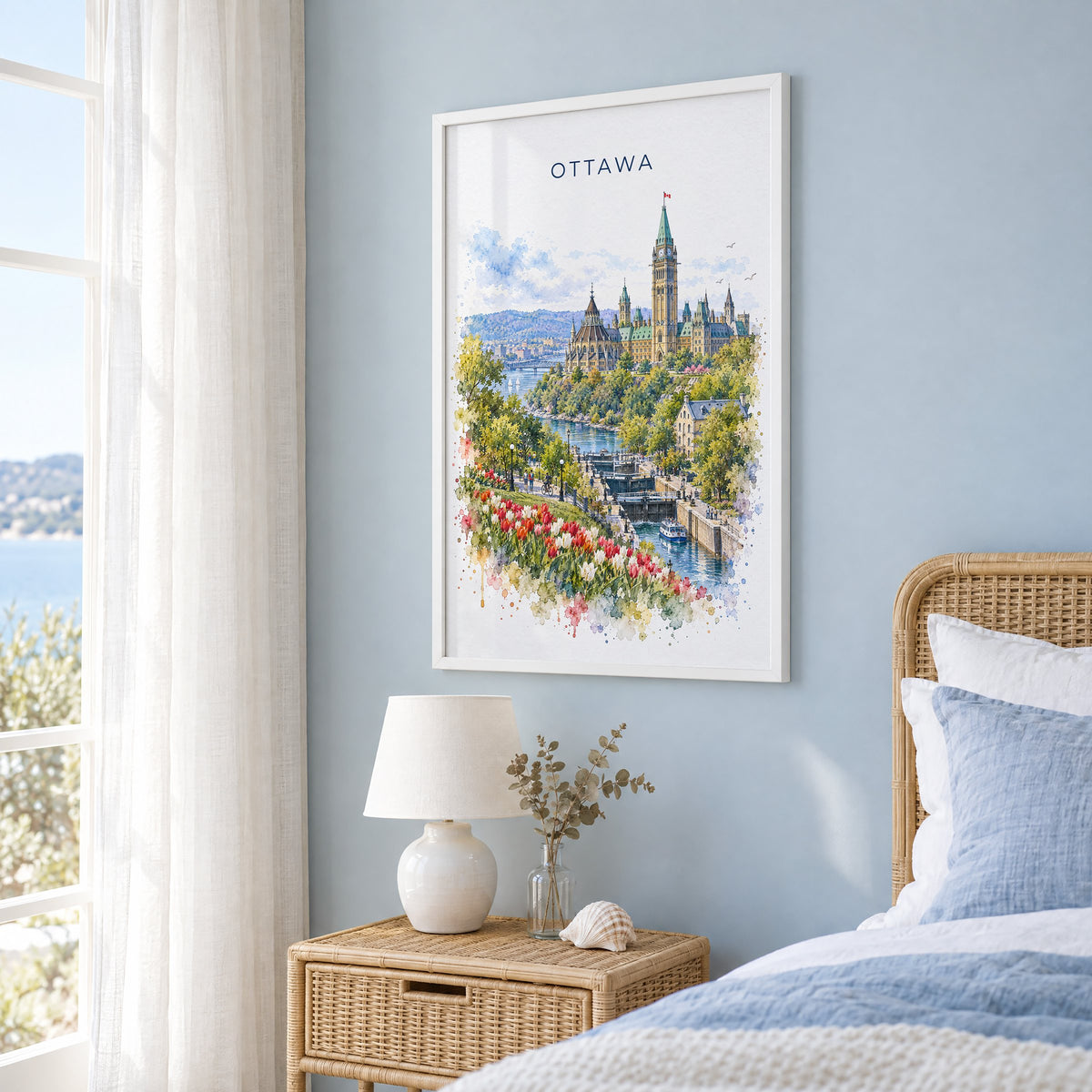 Ottawa watercolor print in a white frame on a pale blue wall beside a rattan bed in a coastal bedroom