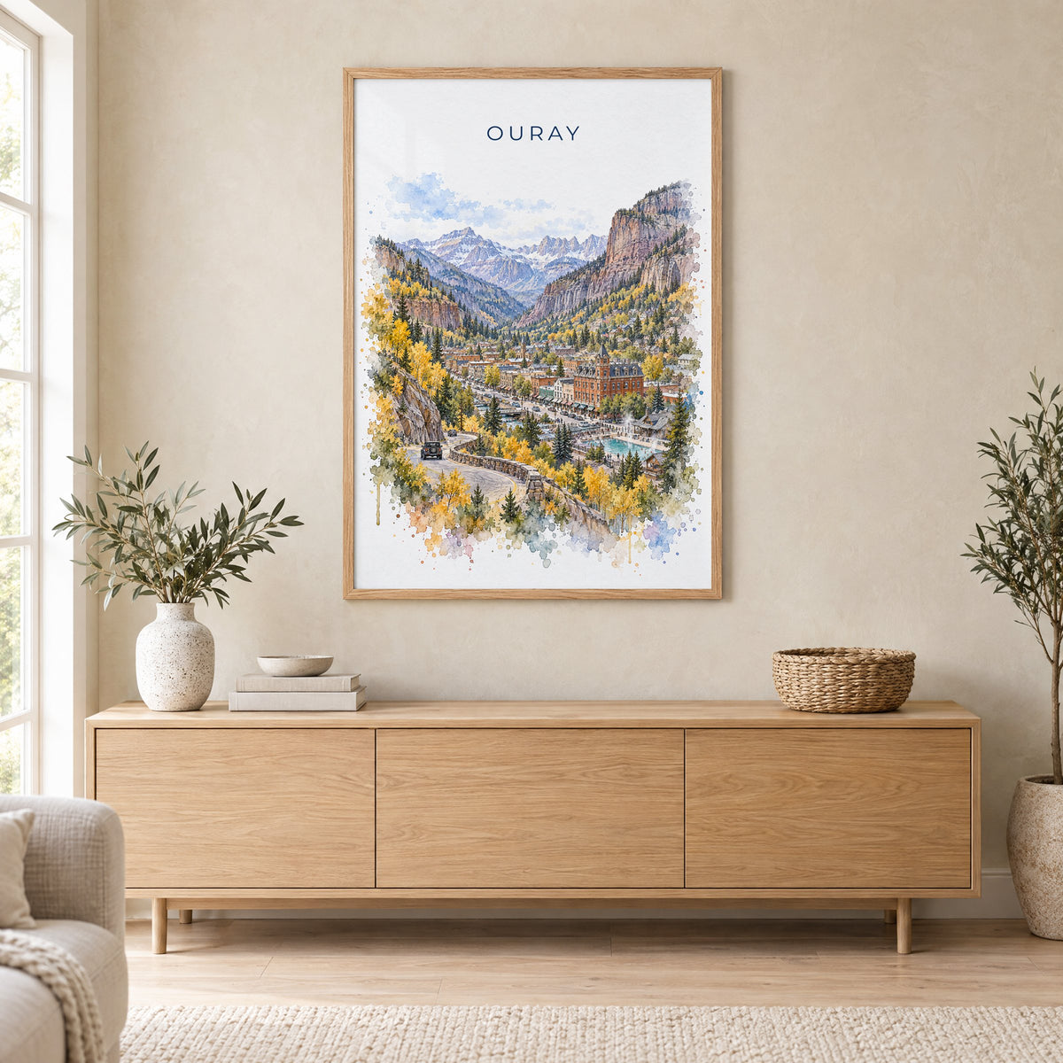 Ouray watercolor print in an oak frame above a light wood sideboard in a Scandinavian living room