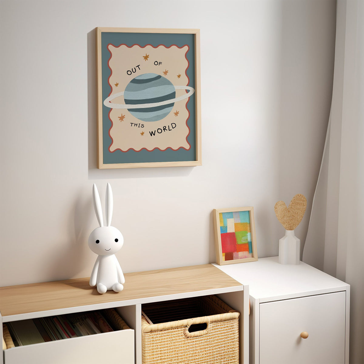 Out of this world planet nursery print in an oak frame above a kids cubby shelf with a woven basket and bunny lamp