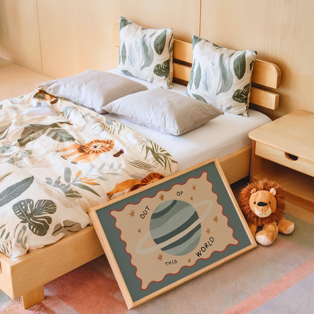 Landscape out of this world planet nursery print in an oak frame leaning on a kids bed by a lion plush