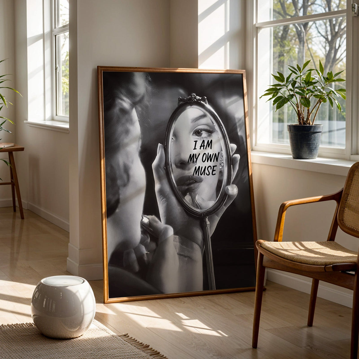I am my own muse hand mirror portrait print in a walnut frame on a wood floor beside a cane chair and sunny window