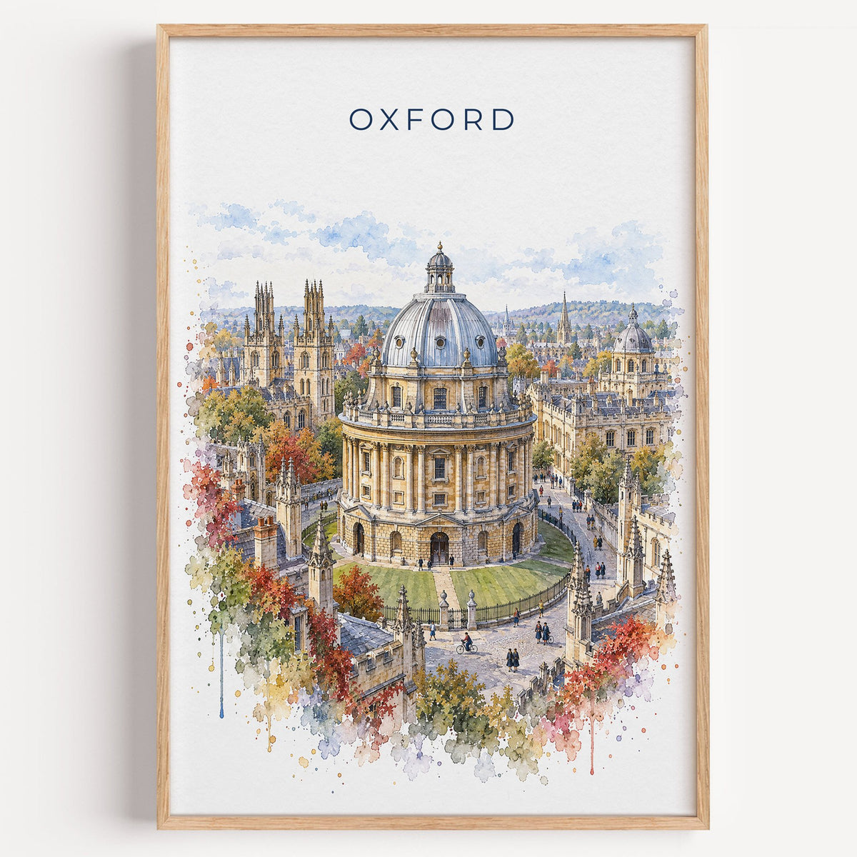 Oxford, England watercolor print in a light oak frame on a plain white wall
