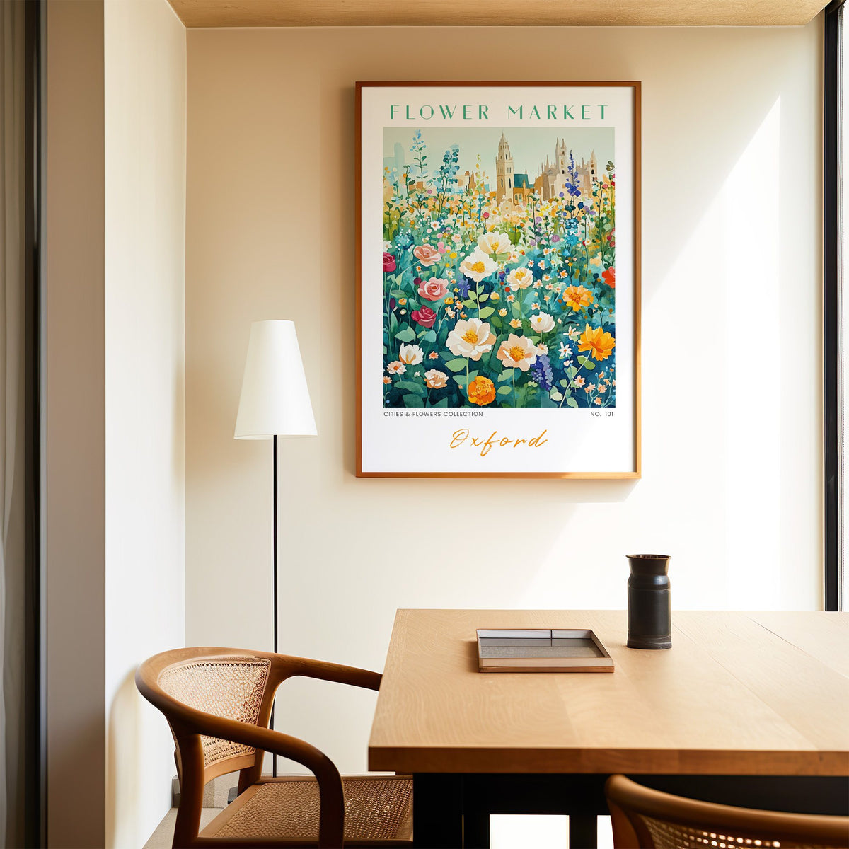 Oxford flower market print in an oak frame above a dining table and cane chair