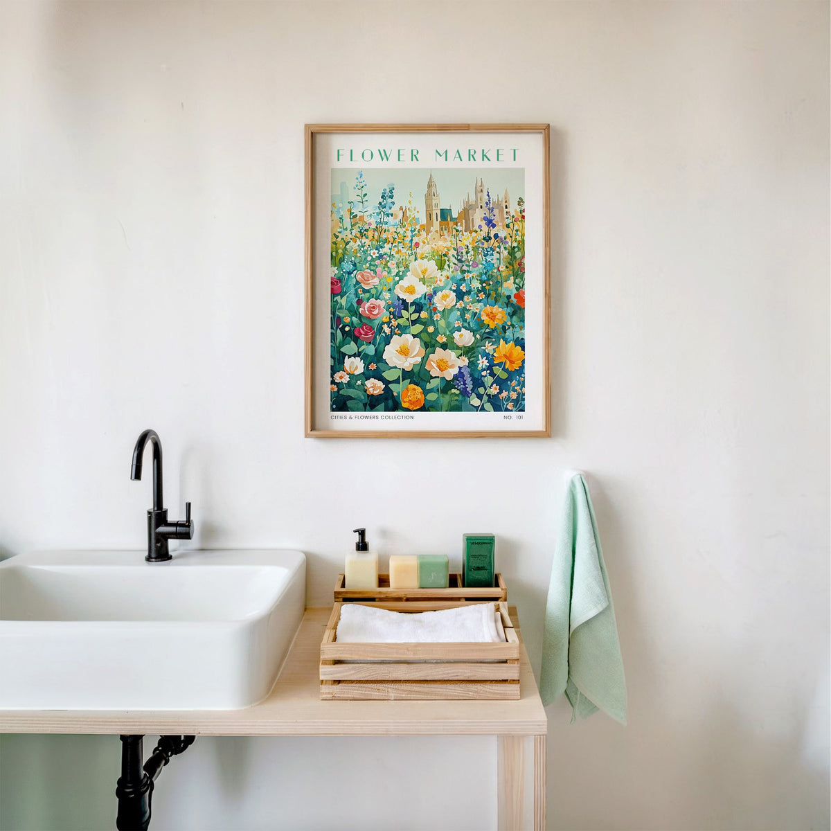 Oxford flower market print in an oak frame above a white bathroom sink with folded towels