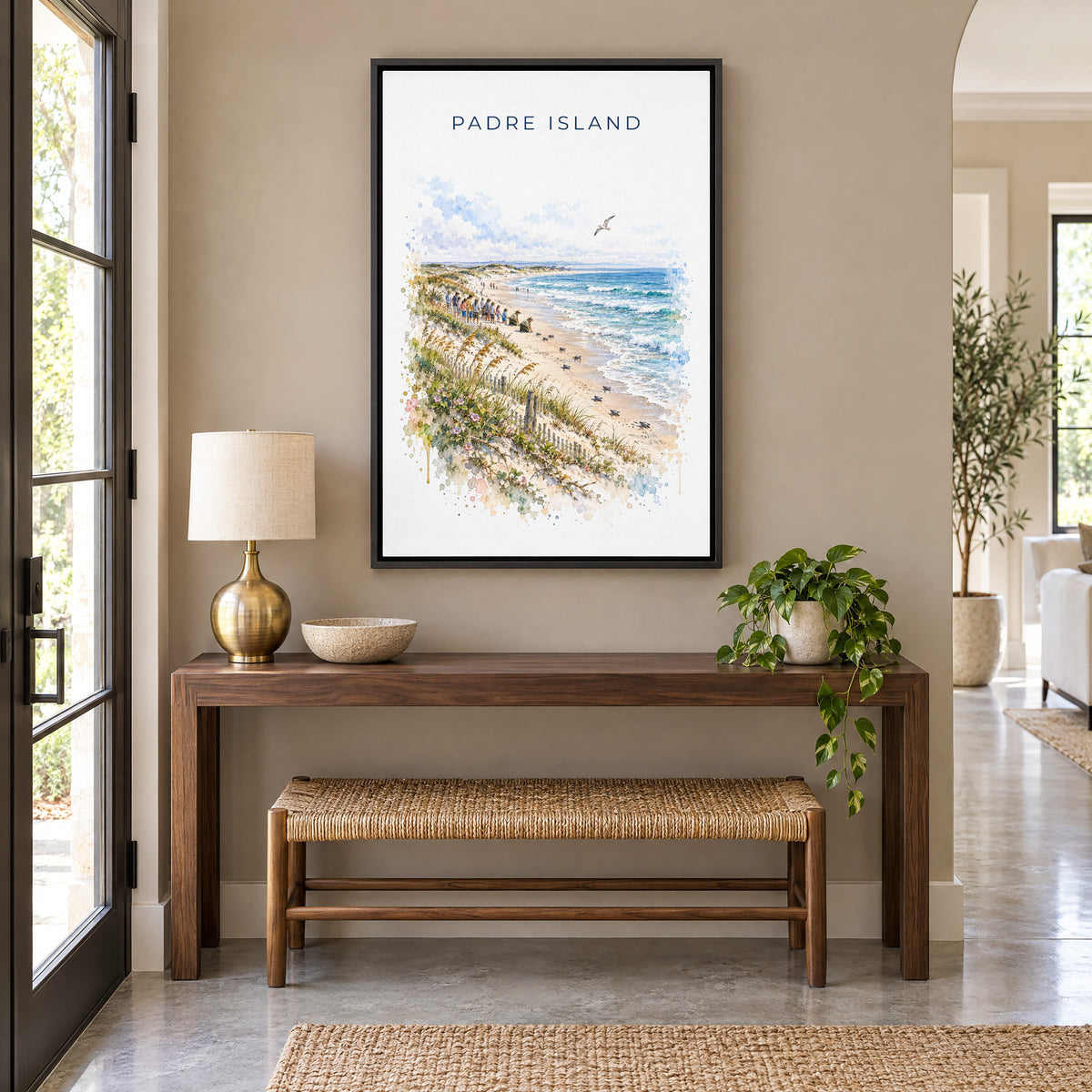 Padre Island National Seashore watercolor as a black floater canvas above a walnut console and woven bench in an entryway