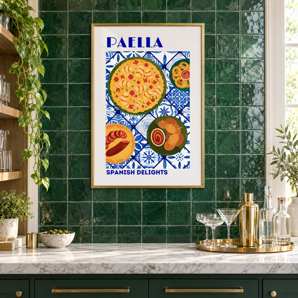 PAELLA Spanish Delights blue tile print in a brass frame on emerald green tiles above a home bar with coupe glasses